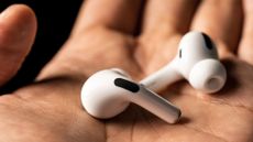 Apple AirPods Pro in someone's hand